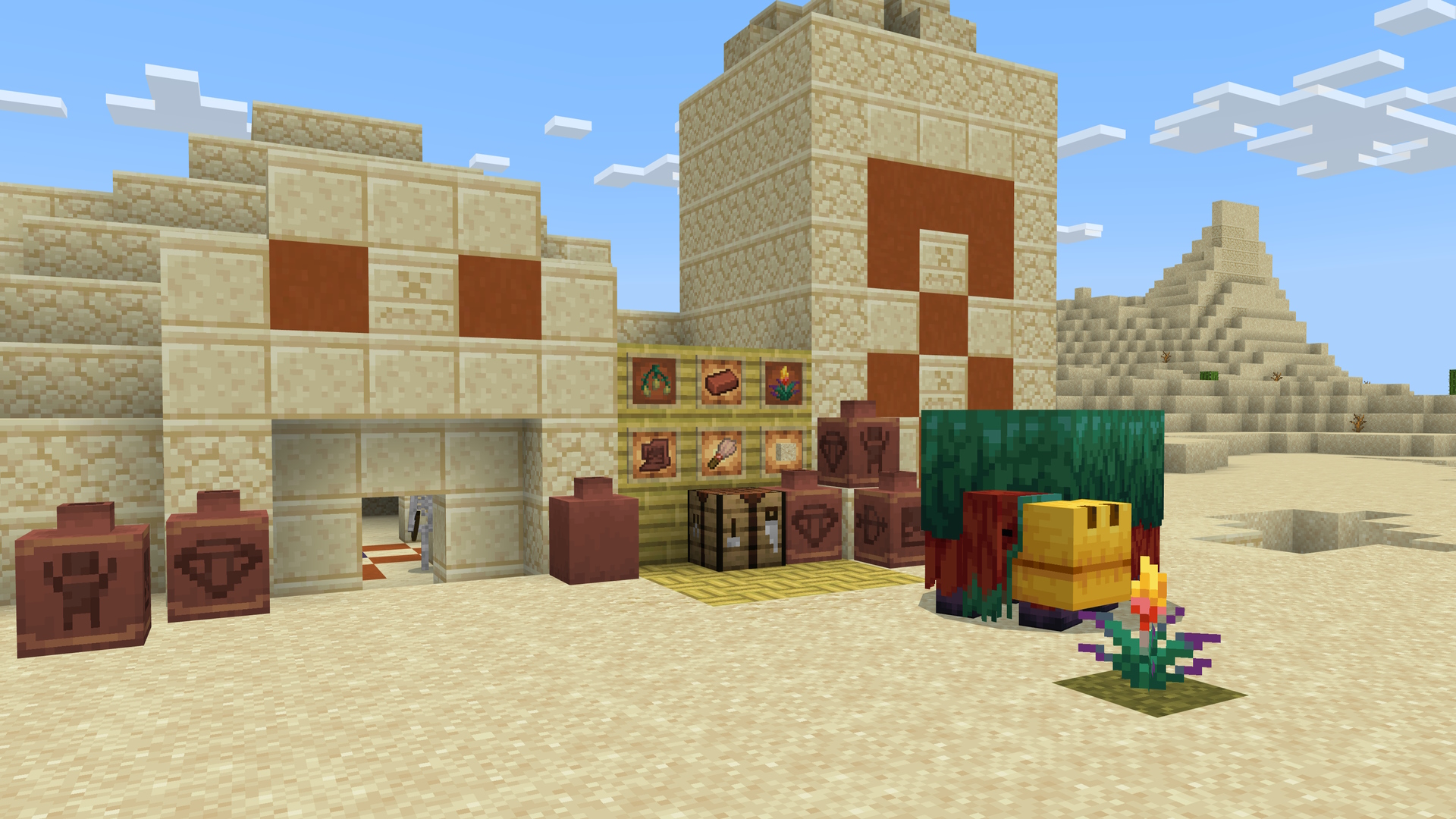 A Minecraft screenshot featuring the sniffer mob and flower, and items related to archaeology including decorated pots, set in front of a desert temple.