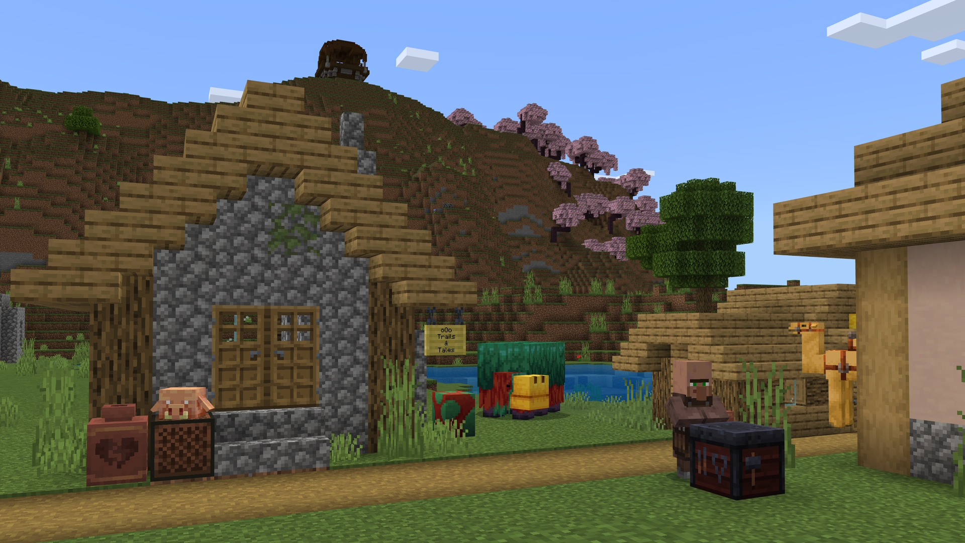 لقطة شاشة من Minecraft تظهر قرية ، قروي ، شمّاس ، مع بستان كرز وبؤرة نهب على جانب جبل في الخلفية.