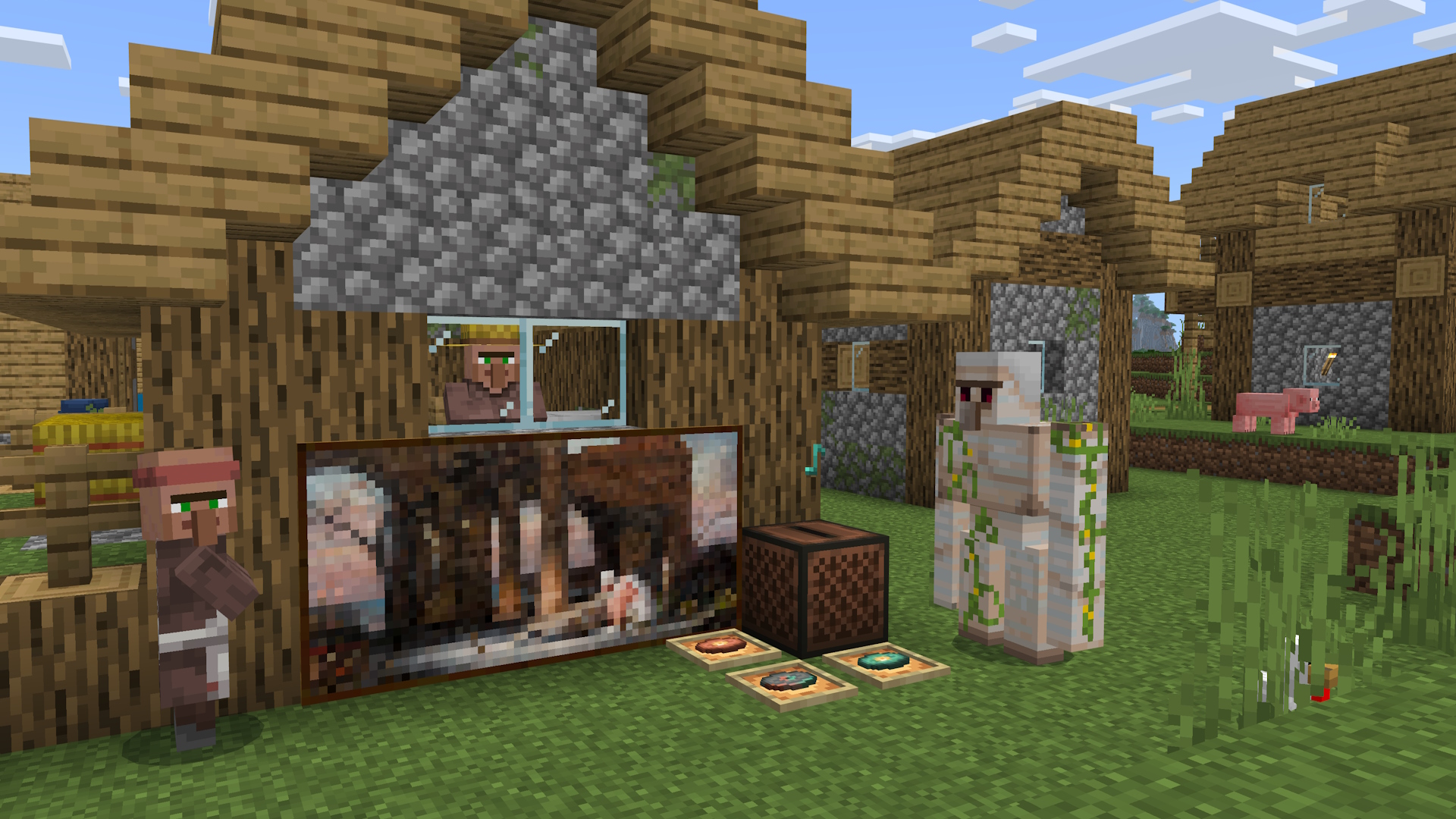 Uma casa de aldeia Minecraft, com aldeões e um golem de ferro próximo. Há uma nova pintura na parede que foi colocada por um tocador, além de uma jukebox e três novos discos de música em molduras no chão.