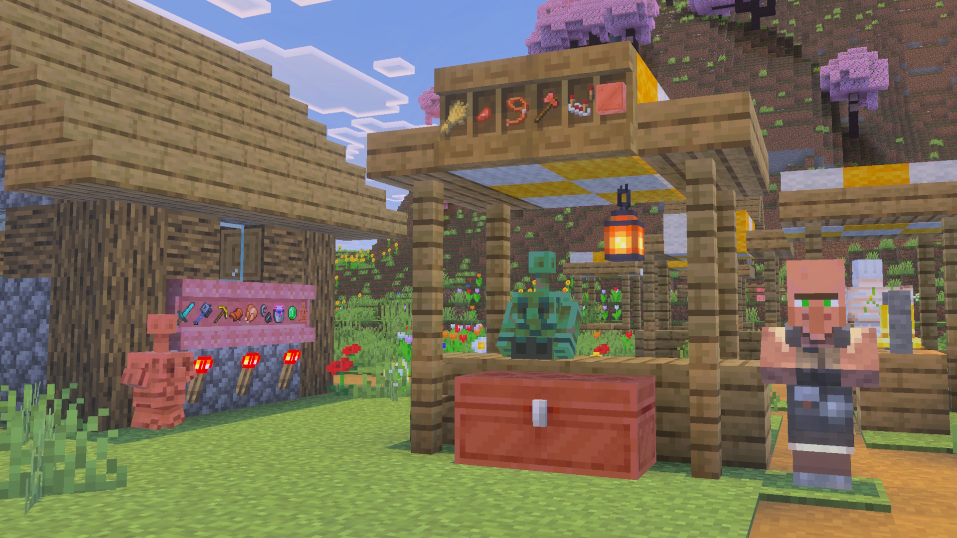 Copper statues in a village setting. There are shelves with items can be seen also.