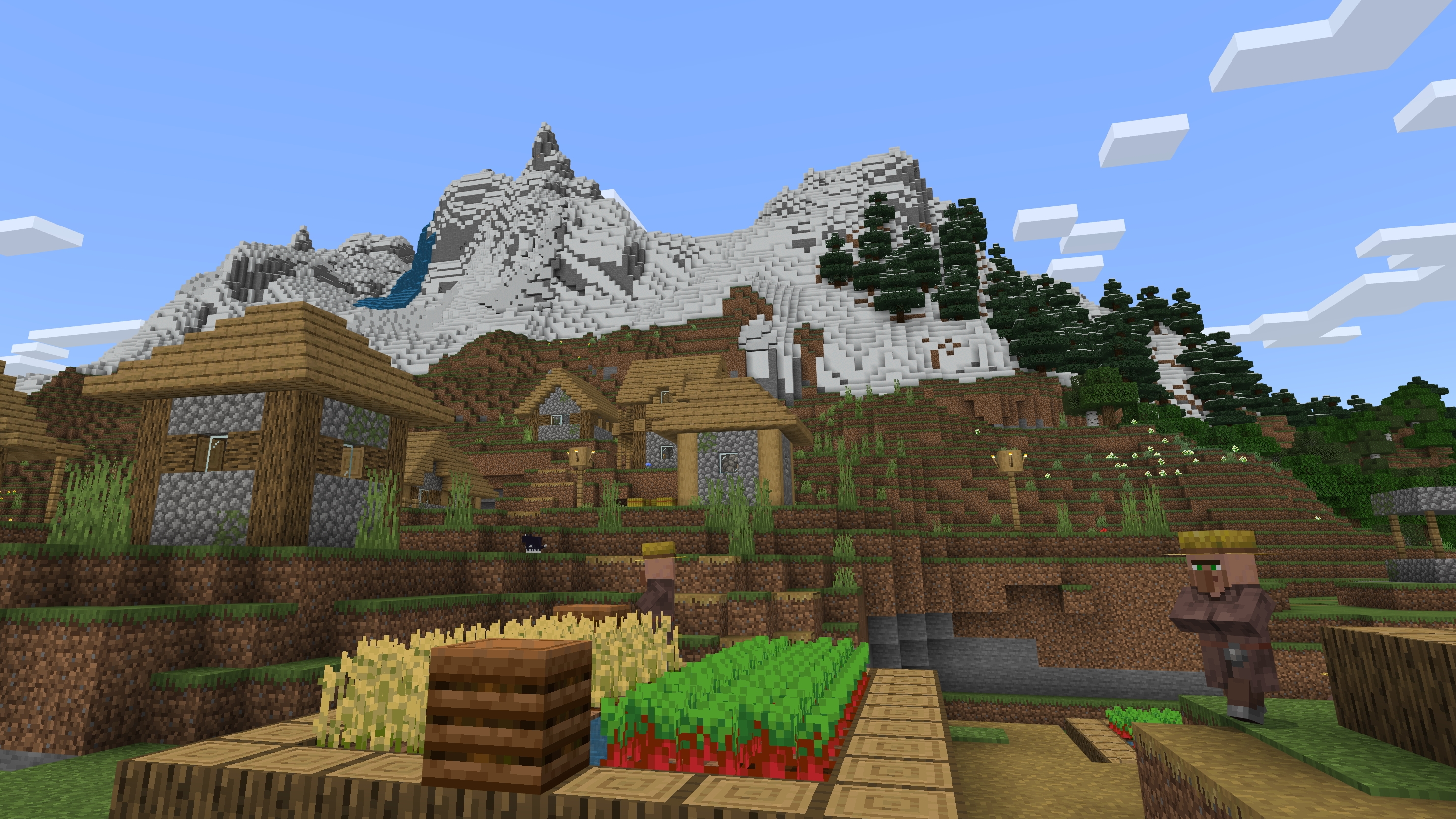 A village in Minecraft with mountains in the background
